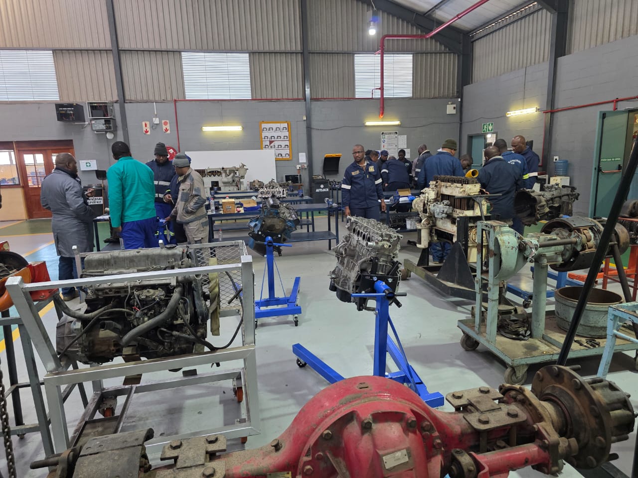 Full training workshop with artisans working on engines